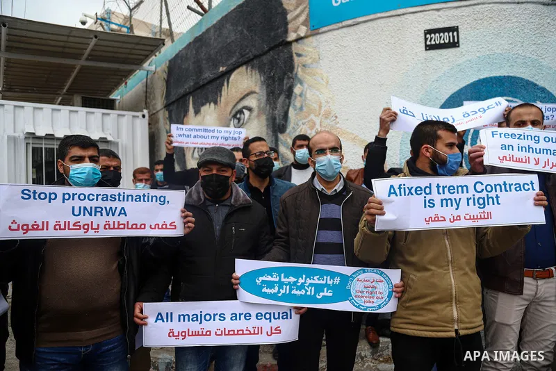Palestinian teachers take part in a protest demanding their rights in front of the headquarters United Nations Relief and Works Agency (UNRWA), in Gaza City on April 11, 2021. The teachers in the United Nations Relief an...