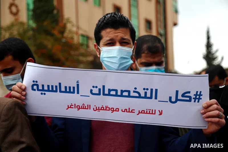 Palestinian teachers take part in a protest demanding their rights in front of the headquarters United Nations Relief and Works Agency (UNRWA), in Gaza City on April 11, 2021. The teachers in the United Nations Relief an...
