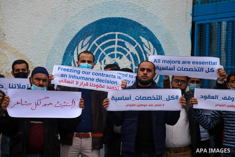 Palestinian teachers take part in a protest demanding their rights in front of the headquarters United Nations Relief and Works Agency (UNRWA), in Gaza City on April 11, 2021. The teachers in the United Nations Relief an...