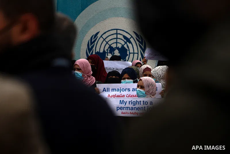 Palestinian teachers take part in a protest demanding their rights in front of the headquarters United Nations Relief and Works Agency (UNRWA), in Gaza City on April 11, 2021. The teachers in the United Nations Relief an...