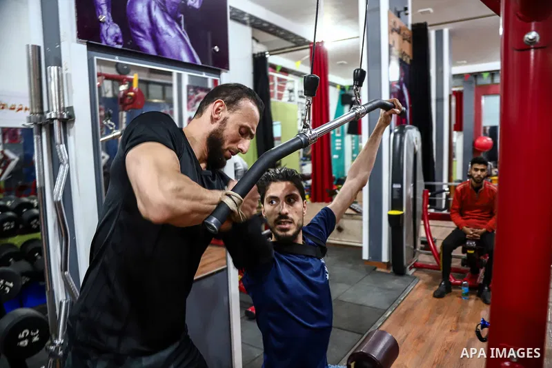 bodybuilder Palestinian, Nidal al-Daour 30, who lost his arm, trains during an exercise session, at his gym, in Beit Lahia, in the northern Gaza Strip, on April 12, 2021. Al-daour lost his arm during the 2008 war during...