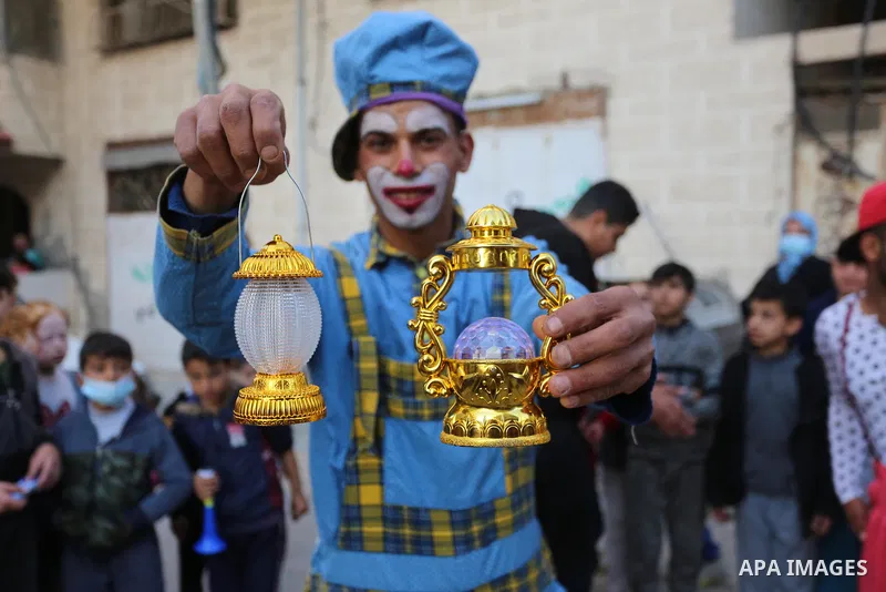 Palestinian clowns wearing protective masks, celebrate with children ahead the Muslim holy month of Ramadan, amid the coronavirus disease (COVID-19), in Khan Younis in the southern Gaza Strip on April 12, 2021. Celebrati...