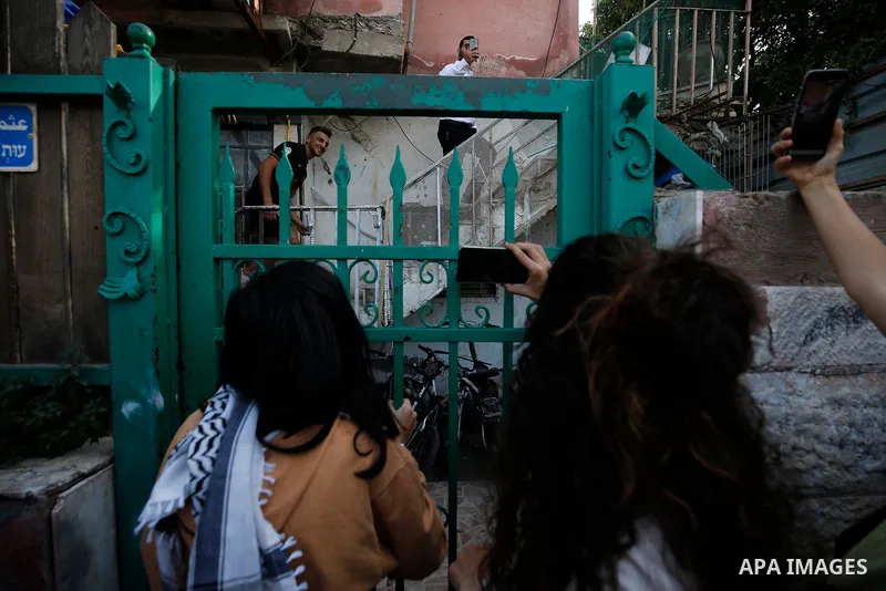 Palestinian and Israeli activists gather in front of Israeli settlers house during a demonstration against the expulsion of Palestinian families from their homes, in the Palestinian neighbourhood of Sheikh Jarrah in Isra...