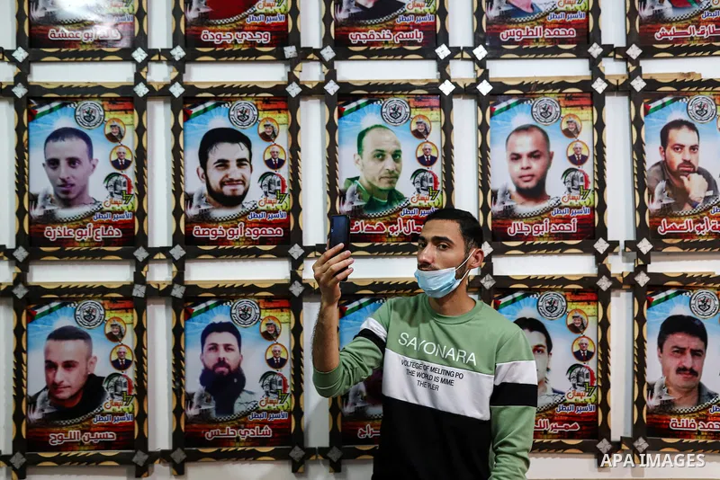 Palestinians take part in an event on Palestinian Prisoner's Day and Palestinians act out a scene of prisoners in Israeli jails, in Gaza City on April 19, 2021. The latest case brings up the number of Palestinian detaine...