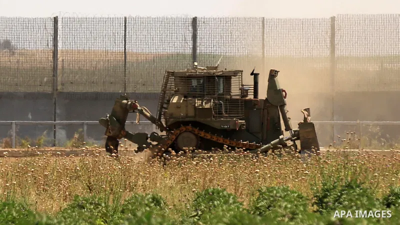 Israeli bulldozers work at the Israel-Gaza border, east of Gaza City on April 21, 2021. The Israeli army today infiltrated Gaza’s border, east of Gaza city, and leveled farmlands. Photo by Ashraf Amra
