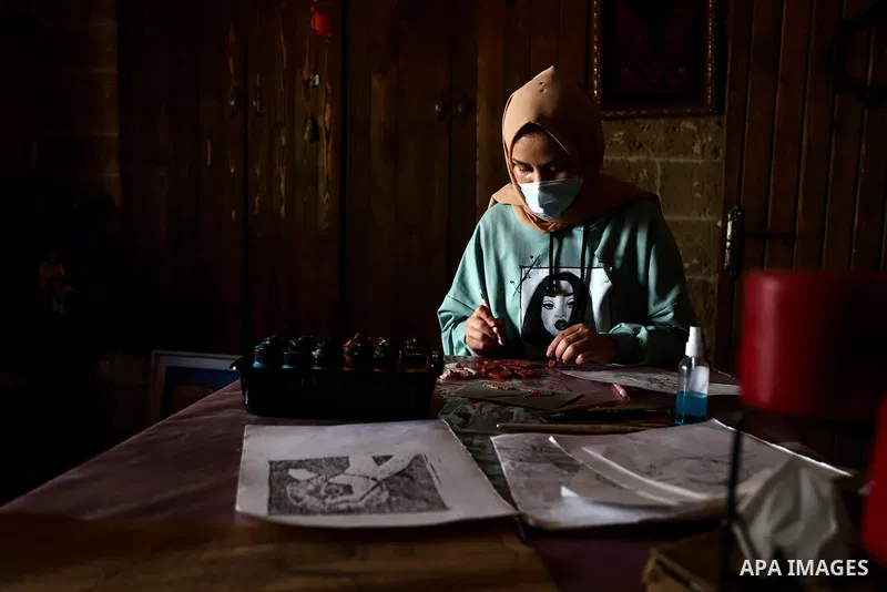 Palestinian artist, Taima Salama, 23, sculptures a clay painting for the blind, in Gaza city, on April 22, 2021. Art paintings in 3D so that they may be touched and felt, both in exhibitions and in people's homes it is t...