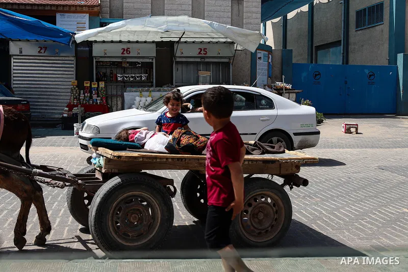 Palestinians walk at street during the Muslim holy month of Ramadan, in Gaza City on April 22, 2021 amid the coronavirus disease (COVID-19) outbreak. Palestinians welcomed the Muslim fasting month of Ramadan under the sh...