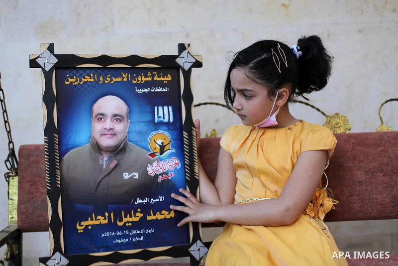 Family of Palestinian prisoner in Israeli jails Mohammed al-Halabi, sit inside their home at Gaza City on April 22, 2021. Palestinian charity worker Mohammed Halabi was seized by Israeli forces on 15 June 2016, he has be...