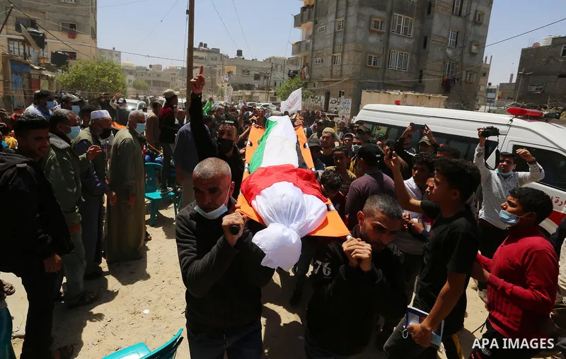 Palestinians carry the body of Yousef Abu Jazar, during his funeral, in Rafah in the southern of Gaza strip, on April 25, 2021. On Thursday, the Israeli occupation authorities delivered the body of the Palestinian child...