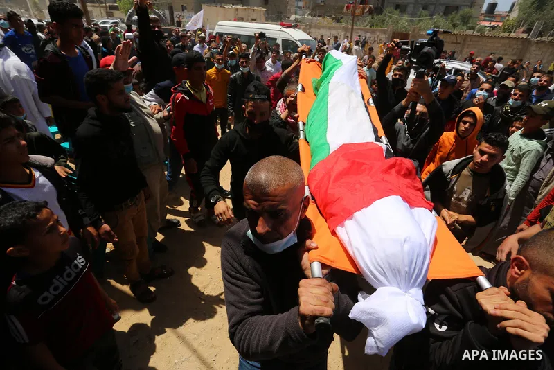 Palestinians carry the body of Yousef Abu Jazar, during his funeral, in Rafah in the southern of Gaza strip, on April 25, 2021. On Thursday, the Israeli occupation authorities delivered the body of the Palestinian child...