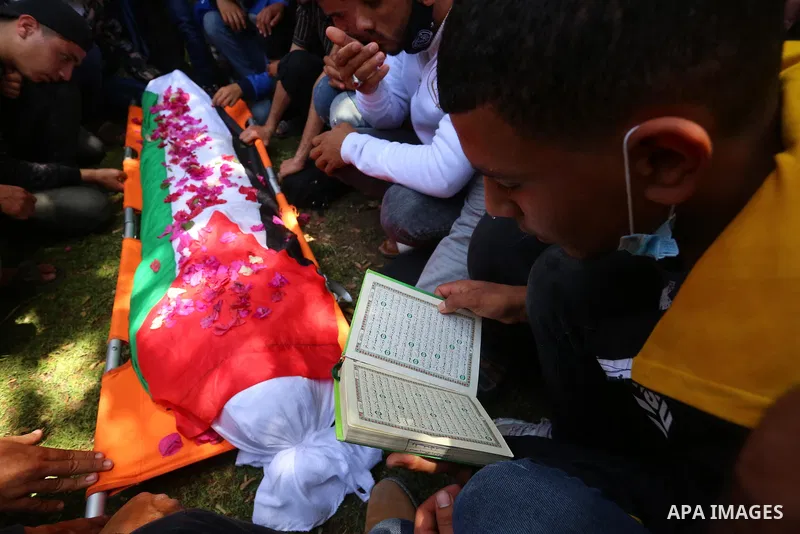 Relatives of the Palestinian Yousef Abu Jazar, mourn during his funeral, in Rafah in the southern of Gaza strip, on April 25, 2021. On Thursday, the Israeli occupation authorities delivered the body of the Palestinian ch...