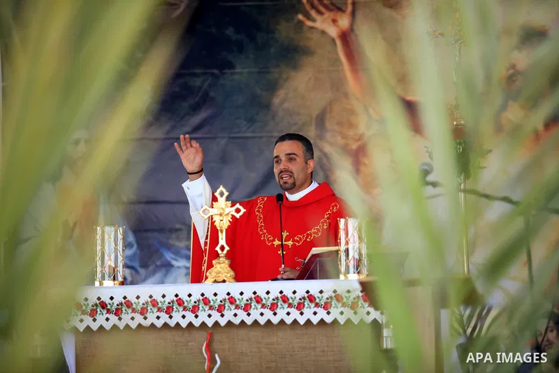 Palestinian Christians attend the Palm Sunday celebrations in the West Bank city of Jenin on April 25, 2021. Palm Sunday is the commemoration of the Entrance of our Lord into Jerusalem following His glorious miracle of r...