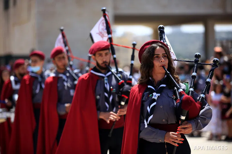 Palestinian scout bands perform during Palm Sunday celebrations in the West Bank city of Jenin on April 25, 2021. Palm Sunday is the commemoration of the Entrance of our Lord into Jerusalem following His glorious miracle...