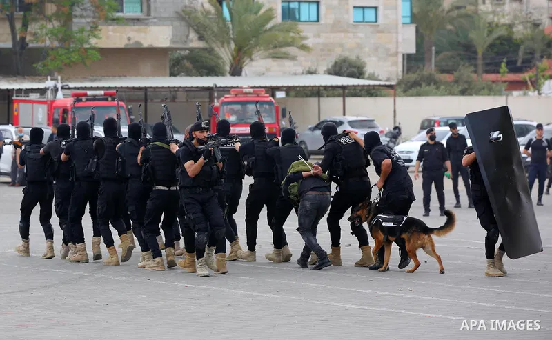 Palestinian policemen wearing protective face masks take part in a graduation ceremony, amid concerns about the spread of the coronavirus disease (COVID-19) at Ribat University College, in Gaza City on April 26, 2021. Th...