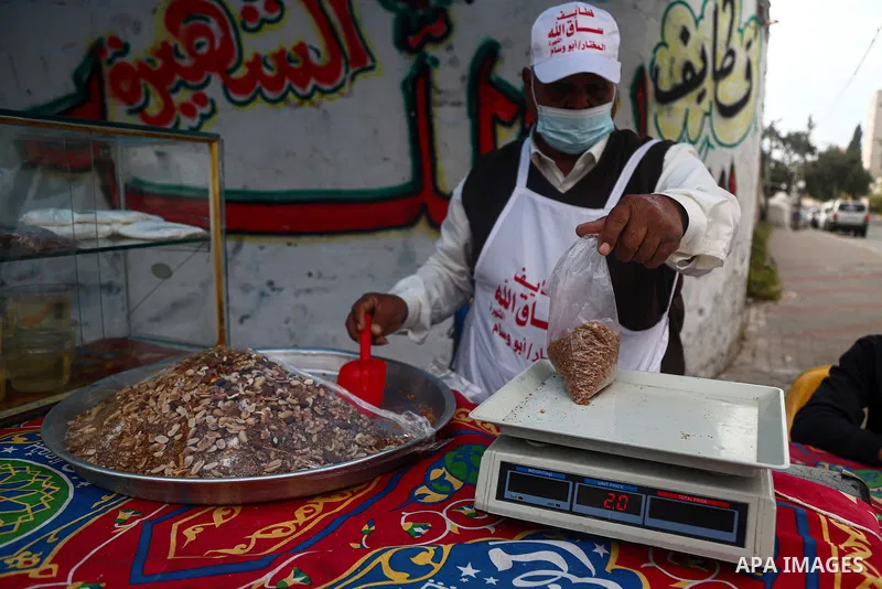 Abu Wisam Saqallah, a Paletsinian man prepares "Qatayef'' traditional pancakes that are popular on Muslim holy month of Ramadan with his family to sell it for customers in Gaza city on April 26, 2021. Celebrations in Gaz...