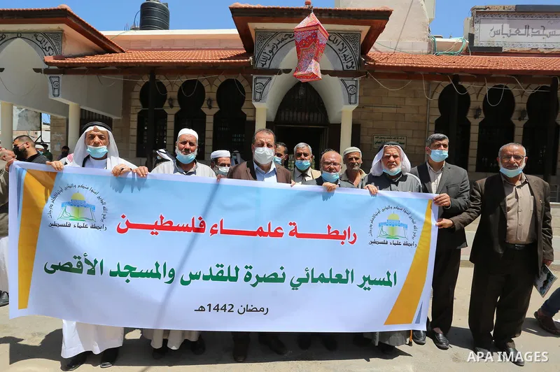 Members of the Palestine Scholars Association, take part in a protest in support of at the Al-Aqsa Mosque, in Gaza city, on April 27, 2021. In Jerusalem, hundreds of Palestinians danced and sang at the Damascus Gate plaz...