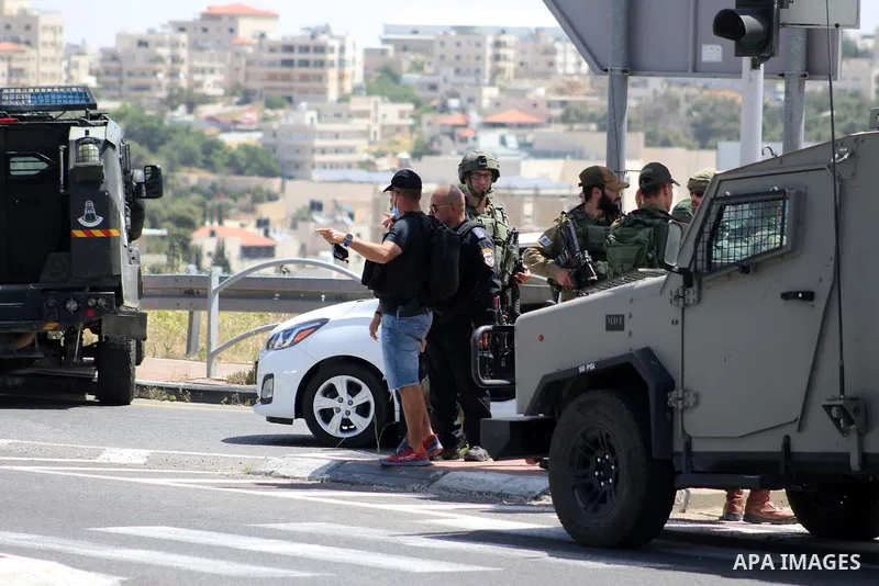 Israeli troops and medics gather at the spot where a suspected Palestinian attempted to stab a soldier on the northern entrance of the Jewish settlement of Efrat south of Bethlehem in the occupied West Bank on April 30,...