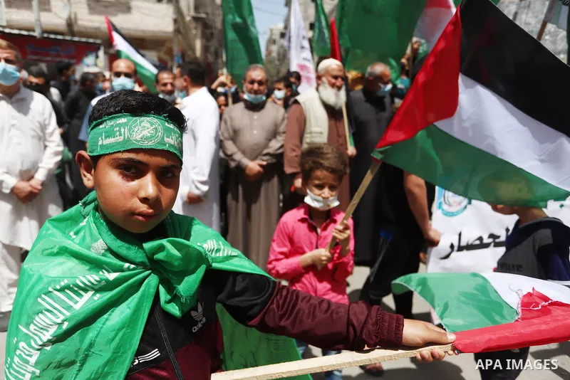 Supporters of the Hamas movement take part in a rally against the decision of the Palestinian authorities president to delay the legislative and presidential polls scheduled for May 22 and July 31, respectively, in Gaza...