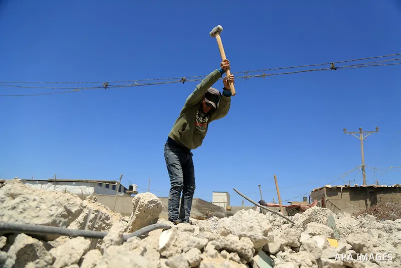 Palestinian workers crush stones and cement blocks from houses marking International Workers' Day, in Gaza city on May 01. 2021. Youth (19- 29 years) are the most group suffering from unemployment. Thus, the unemployment...