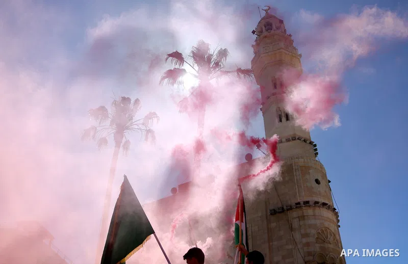 Christian worshippers take part in the Holy Fire ceremony in Bethlehem's Church of the Nativity in the Israeli-occupied West Bank, on May 1, 2021, on the eve of Orthodox Easter. Photo by Mosab Shawer