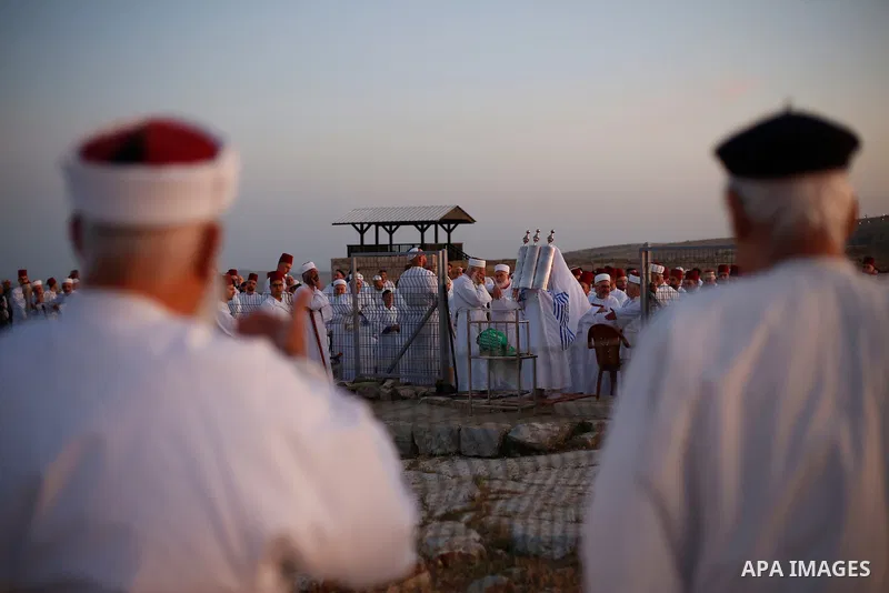 Members of the Samaritan community pray at sunrise during a religious service marking the end of their Passover holiday atop Mount Gerizim, above the West Bank city of Nablus, 02 May 2021. According to tradition, the Sam...