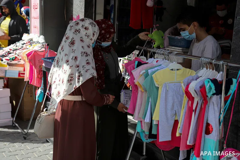Palestinians shop at market days before of Eid al Fitr in Gaza City amid the COVID-19 pandemic on May 04, 2021. People flock markets and shopping malls as they shop for food and new clothings in preparation for Eid al Fi...