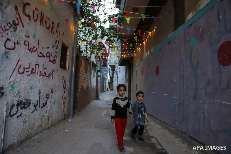 Palestinian enjoy their time near stairs decorated with vibrant colors by volunteers in the al-Daraj neighborhood of Gaza City amid the COVID-19 pandemic on May 04, 2021. Tight precautionary measures to contain the COVID...