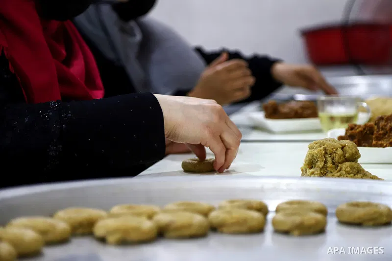 Palestinians prepare traditional date-filled mini cakes at factory, days before of Eid al Fitr in Gaza City amid the COVID-19 pandemic on May 05, 2021. People flock markets and shopping malls as they shop for food and ne...