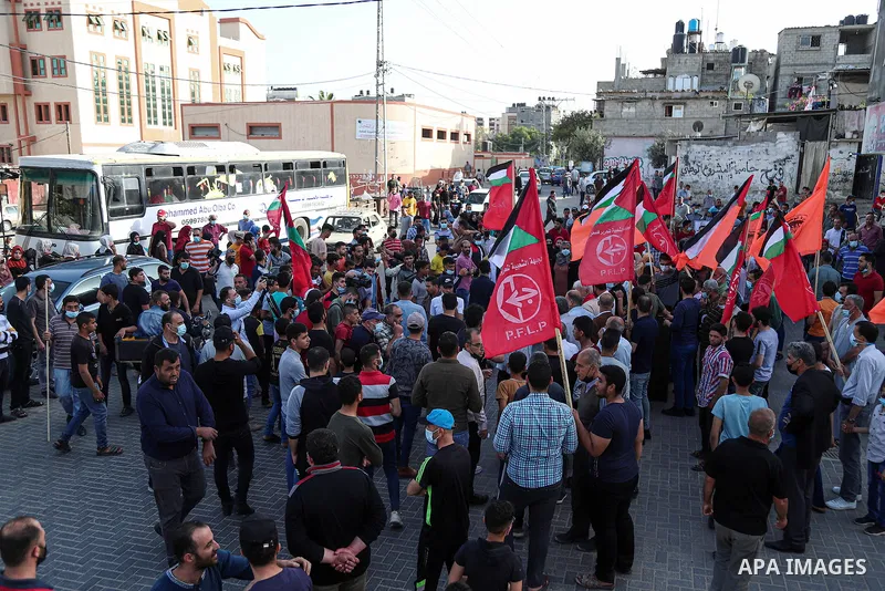 Palestinians take part during a protest against postponement of the Palestinian parliamentary and presidential elections, and against the forcible evictions of Palestinians from their homes in the Sheikh Jarrah neighborh...