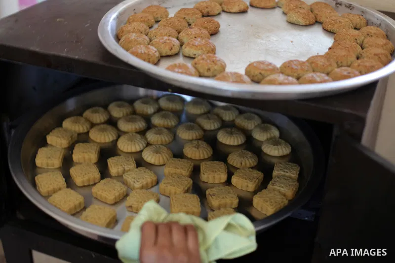 Palestinian women prepare traditional date-filled mini cakes, ahead of Eid al Fitr in Gaza City amid the COVID-19 pandemic on May 06, 2021. Eid al-Fitr this year is different in light of the COVID-19 pandemic. Eid al-Fit...