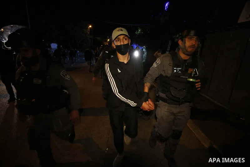 Israeli policemen detain a Palestinian protester amid tension over the possible eviction of several Palestinian families from homes on land claimed by Jewish settlers in the Sheikh Jarrah neighbourhood in East Jerusalem,...