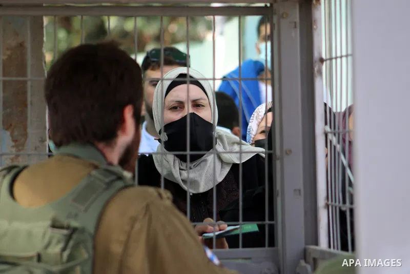 Palestinians wait at the Bethlehem checkpoint in the Israeli-occupied West Bank, to try crossing to Jerusalem to attend the last Friday prayers of the fasting month of Ramadan at the Al-Aqsa mosque, on May 07, 2021. Phot...