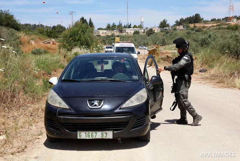 A Palestinian journalist scuffle with a Member of Israeli security near the Salem checkpoint leading to the West Bank town of Jenin, following an attack by Palestinians on an Israeli base, on May 7, 2021. - Two Palestini...