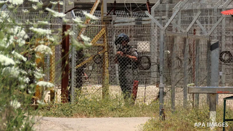 Members of the Israeli security bar the road near the Salem checkpoint leading to the West Bank town of Jenin, following an attack by Palestinians on an Israeli base, on May 7, 2021. - Two Palestinians were killed and a...