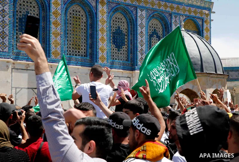 Supporters of the Palestinian Hamas movement gather during a rally to mark al-Quds (Jerusalem) day, following the last Friday prayers of the Muslim fasting month of Ramadan, outside the Dome of the Rock mosque at the al-...