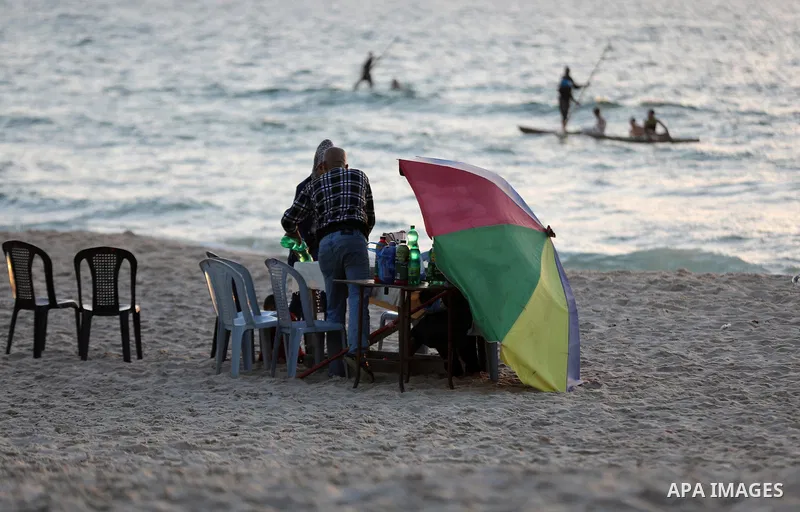 Palestinian families break their fast, after a lockdown due to the coronavirus was lifted, during the Muslim holy month of Ramadan, at the beach in the Gaza city, on May 8, 2021. COVID-19 has claimed the lives of 13 peop...