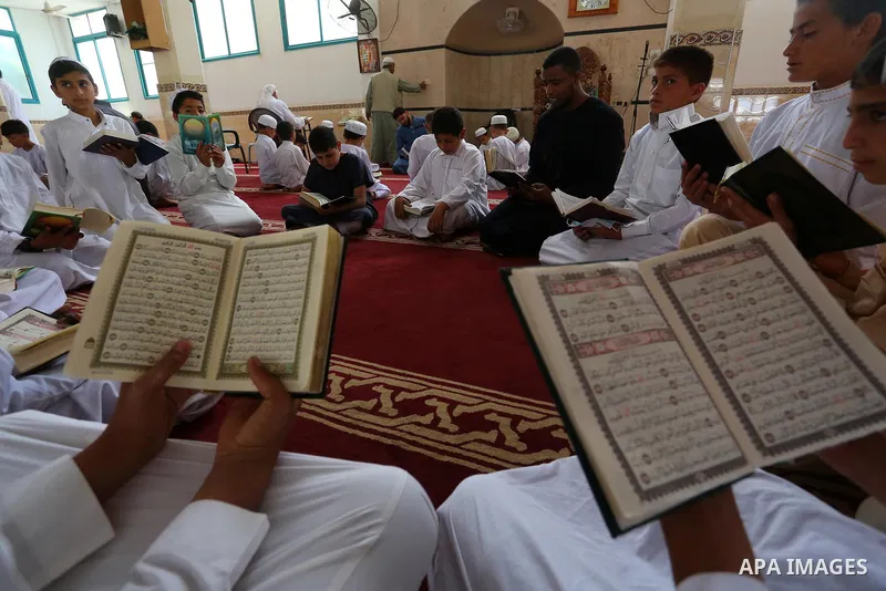 Palestinian children read holy Koran in mosque during the holy month of Ramadan amid the coronavirus COVID-19 pandemic, in Deir al-Balah in the center of Gaza Strip on May 09, 2021. Photo by Ashraf Amra