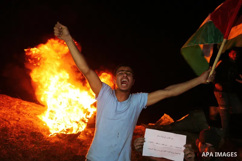 Palestinian protesters burn tires during a demonstration along the Israel-Gaza border, east of Al-Bureij camp, in the center of the Gaza Strip in solidarity the Palestinians in Jerusalem's Sheikh Jarrah neighbourhood, wh...