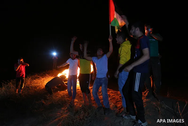 Palestinian protesters burn tires during a demonstration along the Israel-Gaza border, east of Al-Bureij camp, in the center of the Gaza Strip in solidarity the Palestinians in Jerusalem's Sheikh Jarrah neighbourhood, wh...