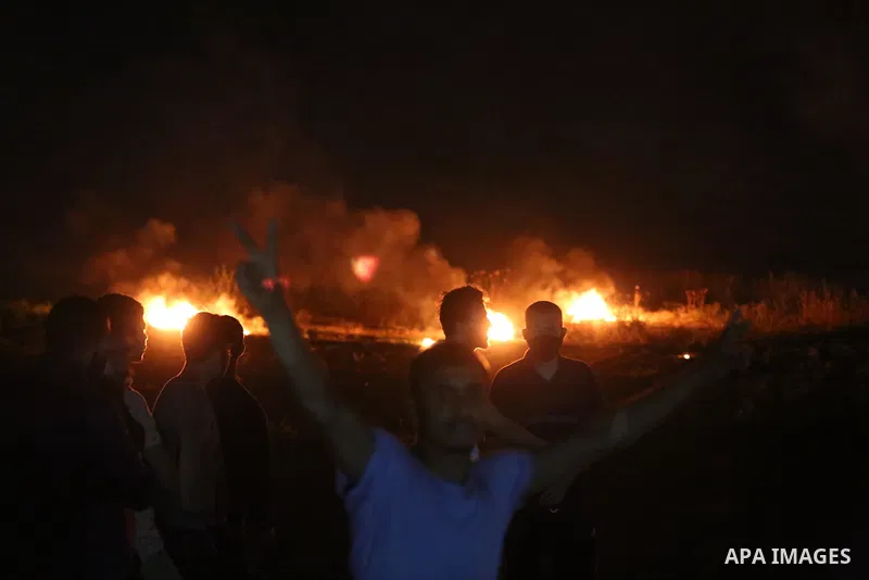Palestinian protesters burn tires during a demonstration along the Israel-Gaza border, east of Al-Bureij camp, in the center of the Gaza Strip in solidarity the Palestinians in Jerusalem's Sheikh Jarrah neighbourhood, wh...