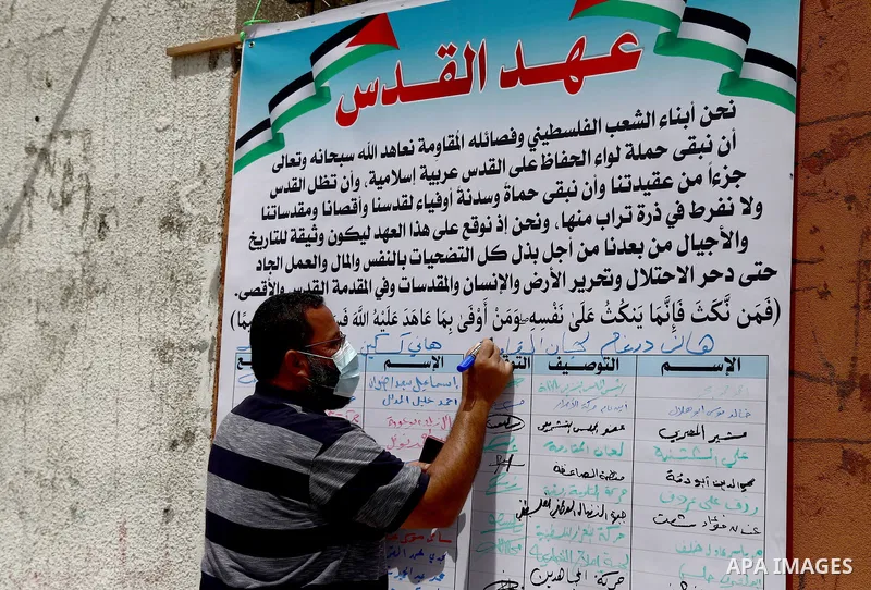 Members of the Palestinian factions take part in a prtoest in solidarity with the Al-Aqsa Mosque, in front of the Legislative Council headguarter, in Gaza city, on May 10, 2021. Palestinian protesters threw rocks and Isr...