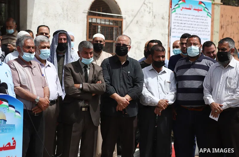 Members of the Palestinian factions take part in a prtoest in solidarity with the Al-Aqsa Mosque, in front of the Legislative Council headguarter, in Gaza city, on May 10, 2021. Palestinian protesters threw rocks and Isr...