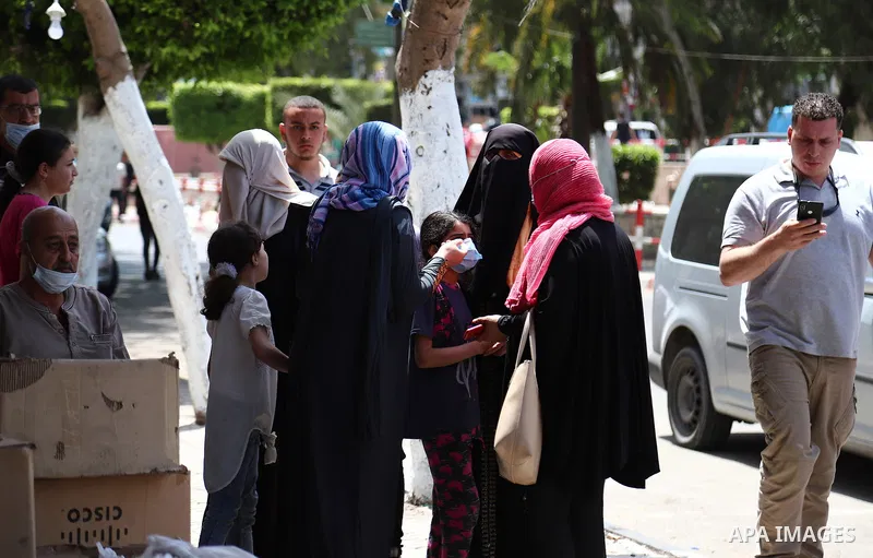 Palestinians evacuate a building targeted by Israeli bombardment in Gaza City on May 11, 2021. Israel continued overnight and early this morning its airstrikes on the Gaza Strip, causing heavy damage to various locations...