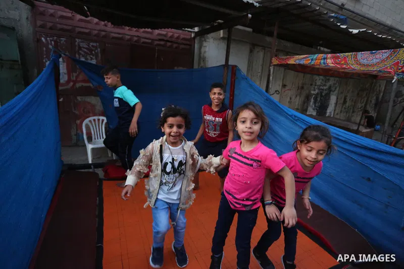Palestinian children celebrate the first day of Eid Al-Fitr in Gaza City, as Israel continued its heavy bombardment of the Palestinian enclave, May 13, 2021. The deadly exchange of fire between Palestinian militants in t...