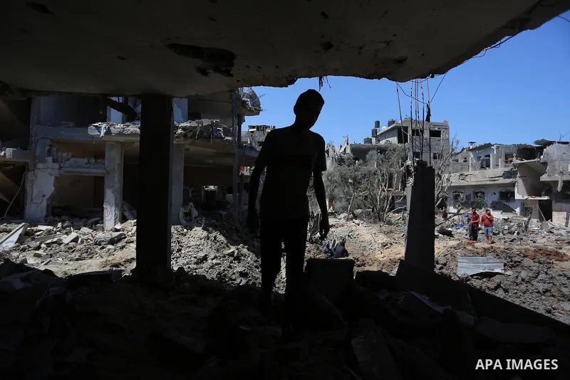 Palestinians inspect their homes that was destroyed by an Israeli airstrike, in Beit Hanoun in the northern Gaza Strip on May 14, 2021. Local sources said Israeli fighter jets carried out a crazy barrage of about 160 air...