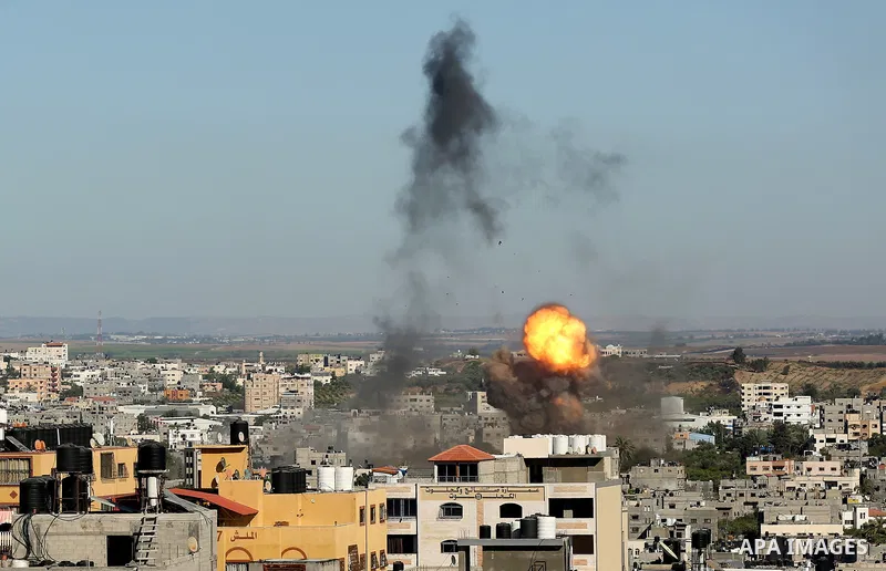 Smoke rises following Israeli airstrikes on a building in Gaza City on May 15, 2021. Israel faced a widening conflict on May 14, as deadly violence erupted across the West Bank amid a massive aerial bombardment in Gaza a...