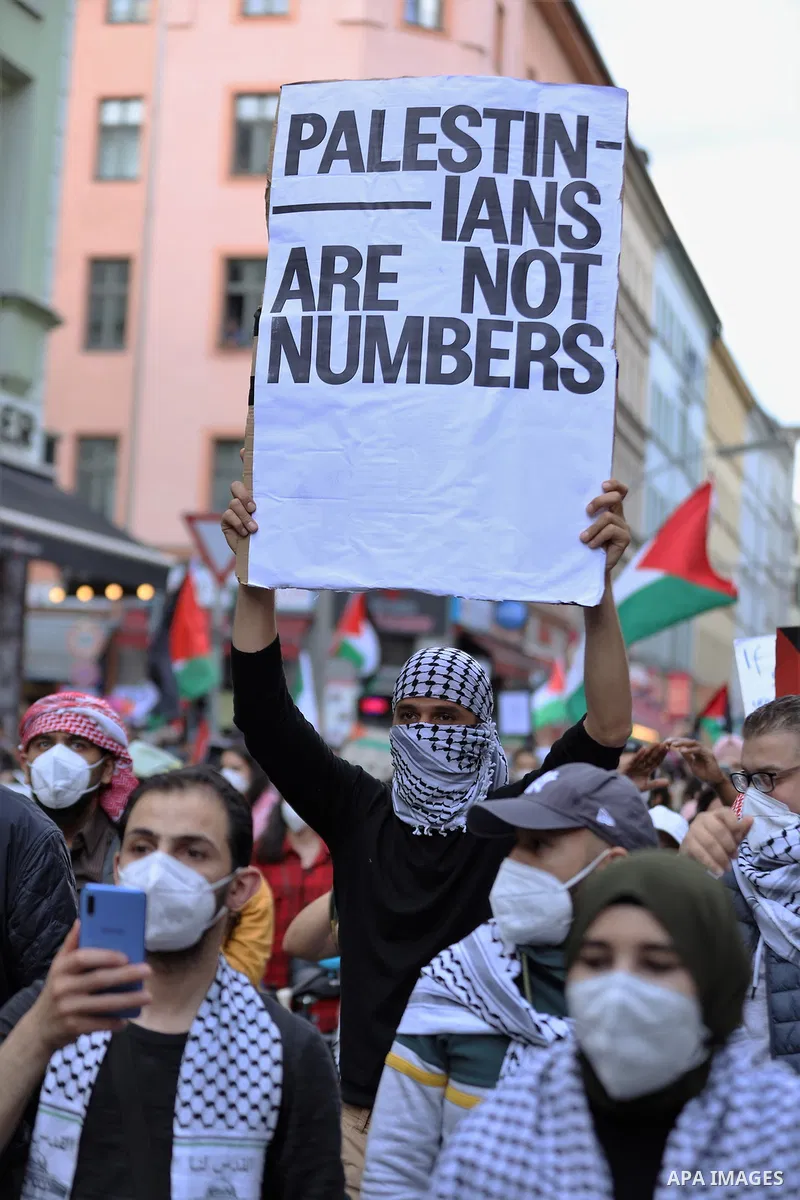 People attend a protest rally in solidarity with Palestinians in Berlin, Germany, Saturday, May 15, 2021. According to the Palestinian Ministry of Health, at least 140 Palestinians, including 39 children, were killed in...