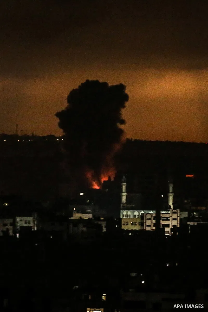 Smoke billows from a fire following Israeli airstrikes on multiple targets in Gaza City, early on May 16, 2021. Israel pummelled the Gaza Strip with air strikes, killing 10 members of an extended family and demolishing a...