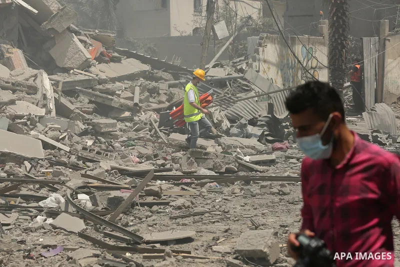 Palestinians inspect building after it is destroyed in an Israeli airstrike in Gaza city on May 16, 2021. Israel's army said it had bombed the home of the political leader of Islamist group Hamas in the Gaza Strip, as th...