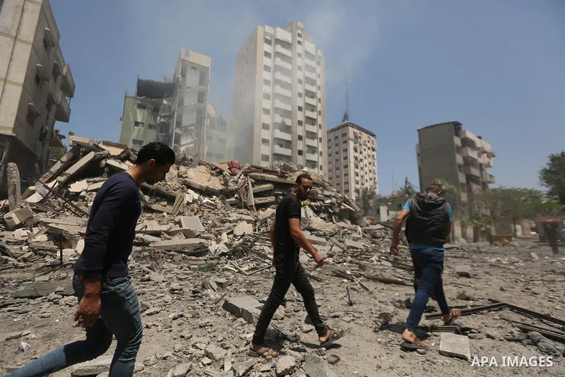 Palestinians inspect building after it is destroyed in an Israeli airstrike in Gaza city on May 16, 2021. Israel's army said it had bombed the home of the political leader of Islamist group Hamas in the Gaza Strip, as th...